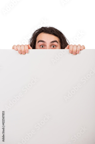 Принти на полотні Fearful man lurking behind a blank whiteboard