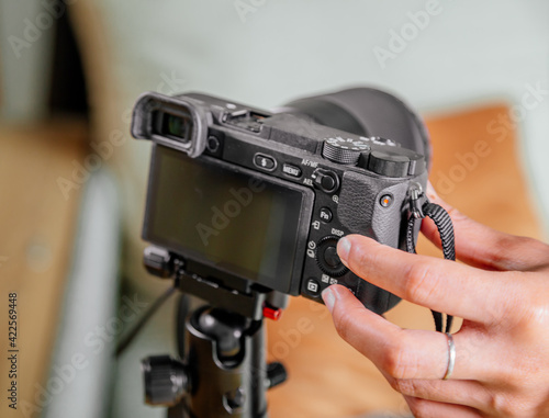 Asian female blogger setting up her digital camera before making a new video for vlog