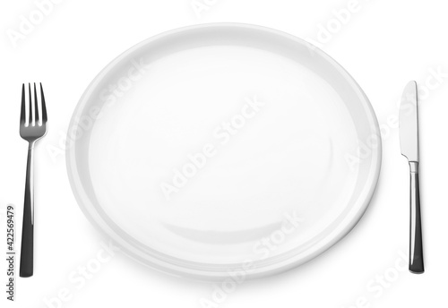 Empty plate and cutlery on white background. Table setting