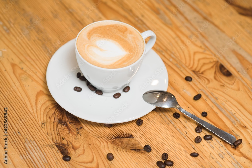 Obraz premium Delicious and aromatic cappuccino coffee on the table in a coffee shop