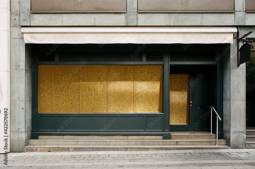 closed and locked restaurant, blocked shop front, impact of the coronavirus pandemic 2021.