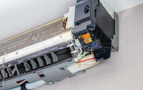 Technician disassembling air conditioner and preparing it for cleaning, Maintenance and repairing concepts © JU.STOCKER