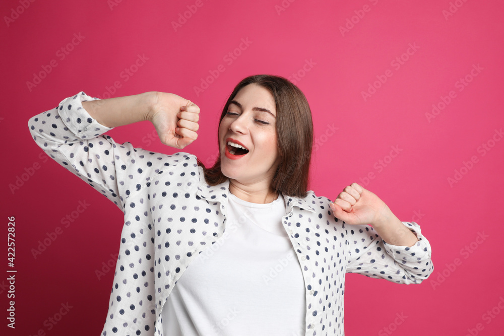 Young tired woman yawning on pink background Young tired woman yawning on pink background