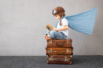 Happy child dreaming about summer vacation and travel