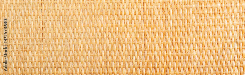 Yellow rattan texture. Copy space. Close up photo