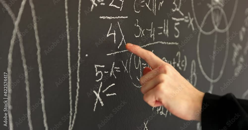 Hands closeup on chalk board writing formulas Hands closeup on chalk board writing formulas