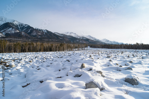 The bed of the stone river was formed after a mudflow in 2014. Early spring. Mountains in the background. Arshan resort, Republic of Buryatia, Russia, Siberia © ANDREI