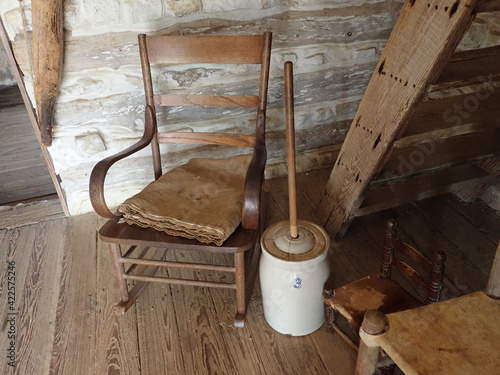 Fotografia Old Butter Churn by a chair