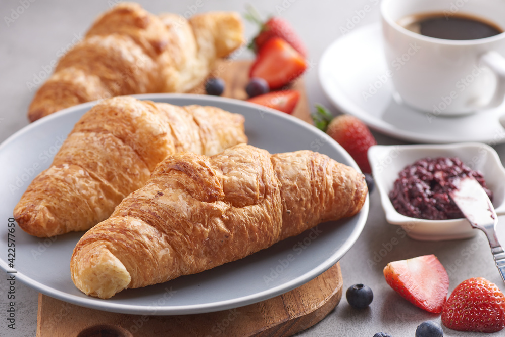 Continental breakfast with assortment of pastries, croissants, Strawberry Jam, coffees and fresh strawberries..