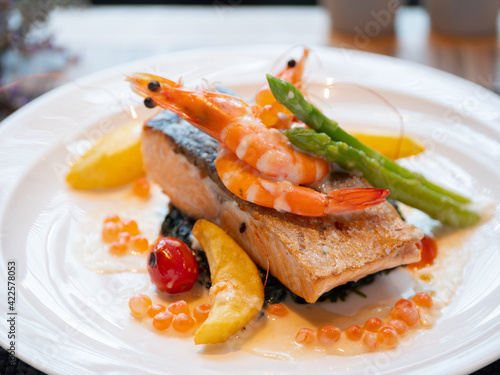 Western Menu - grilled salmon topped with a creamy white sauce served with spinach and asparagus