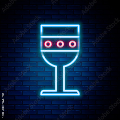 Glowing neon line Medieval goblet icon isolated on brick wall background. Colorful outline concept. Vector