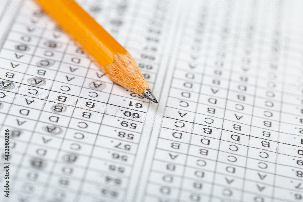 testing in exercise and exam paper. computer sheet with pencil in school test room, education concept. filling in answers in pencil testing in exercise and exam paper. computer sheet with pencil in school test room, education concept. filling in answers in pencil