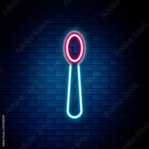 Glowing neon line Disposable plastic spoon icon isolated on brick wall background. Colorful outline concept. Vector
