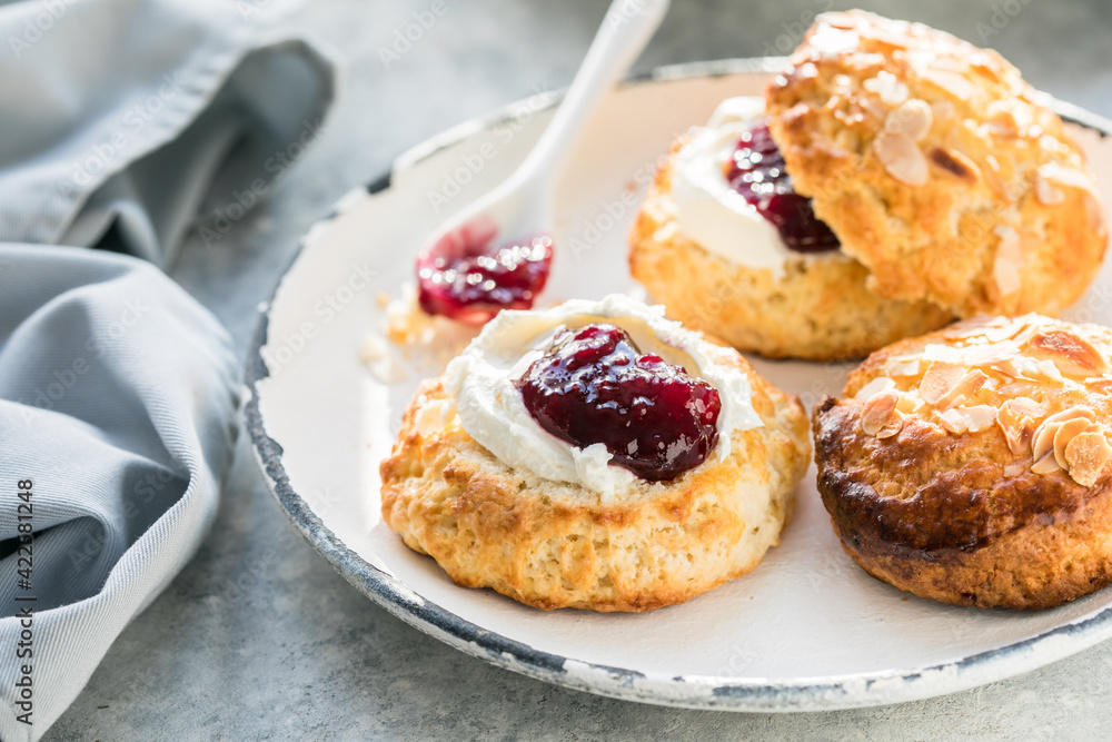 Traditional British Scones with clotted cream, raspberry jam. Traditional British Scones with clotted cream, raspberry jam.