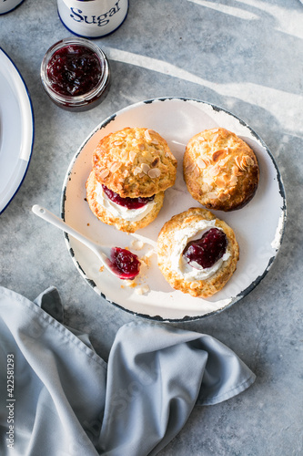 Quadro su tela Traditional British Scones with clotted cream, raspberry jam.