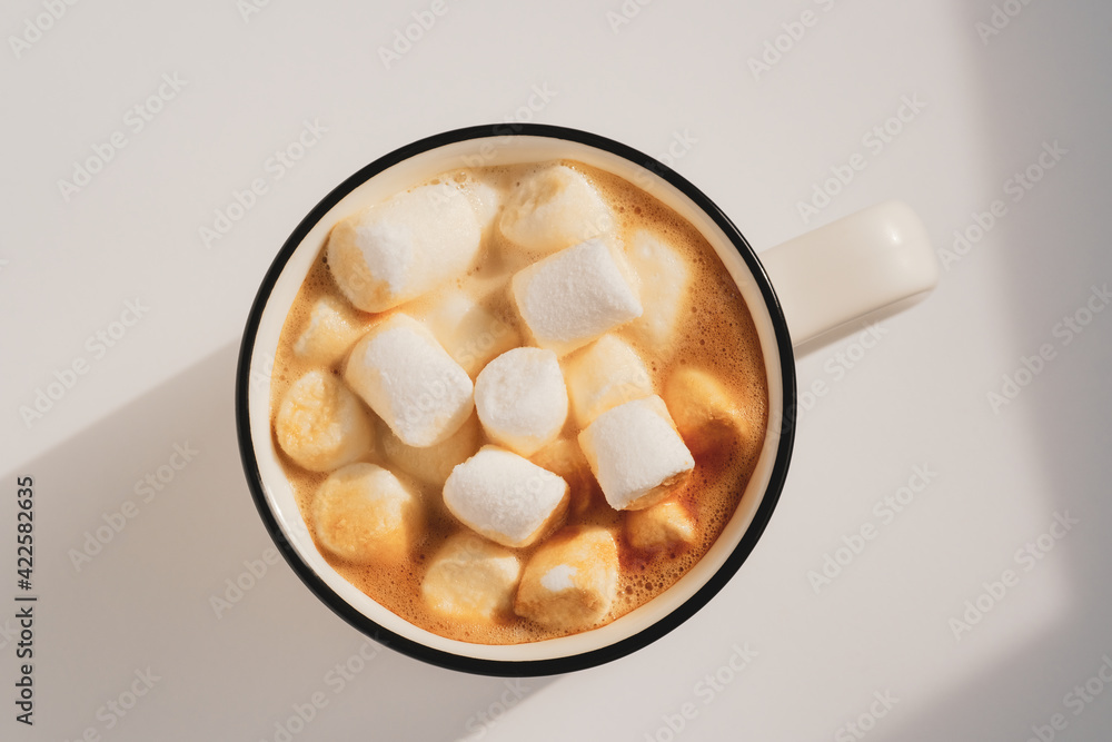 Morning coffee cup with marshmallow. Closeup, top view. Sunny atmospheric minimalistic concept Morning coffee cup with marshmallow. Closeup, top view. Sunny atmospheric minimalistic concept