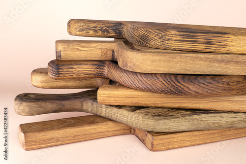 Stack of cutting boards for the kitchen on beige background.