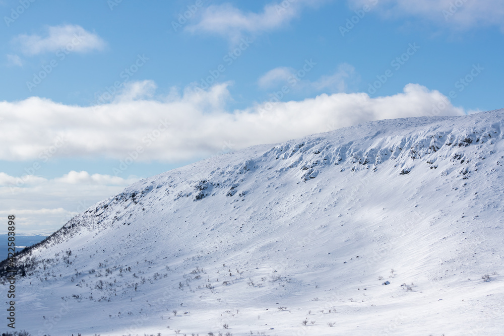 Obraz premium Snow covered mountain with sunlight and shadows.Shot in Sweden, Scandinavia