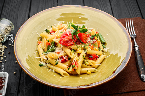 Tomato and Bacon Penne Pasta on a wooden table