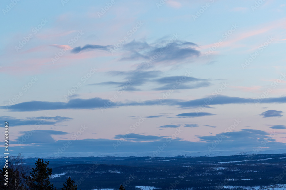 Cloud formation in warm colors at dusk. Shot in Sweden, Scandinavia.