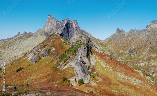 View Mountain peaks and rocks with passes between lakes Svetloye and Zolotarnoe in Ergaki steep rocks blue sky
