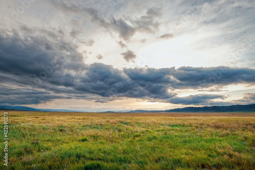 Fields and open spaces in the steppes of Tuva against the background of sunset clouds in autumn it is time to harvest cereals