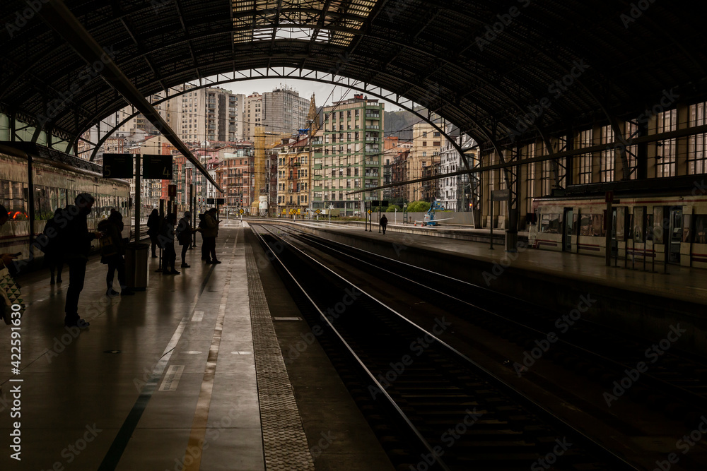 People waiting in the train station People waiting in the train station