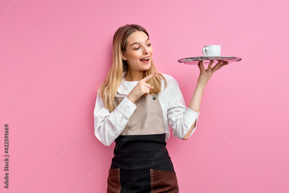 Attractive caucasian waitress woman in apron holding tray with cup, index finger