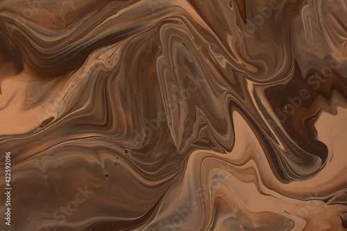 Abstract background in dark caramel tones.Make up concept.Beautiful stains of liquid nail laquers.Fluid art,pour painting technique.Good as digital decor or wallpaper for phone,copy space.