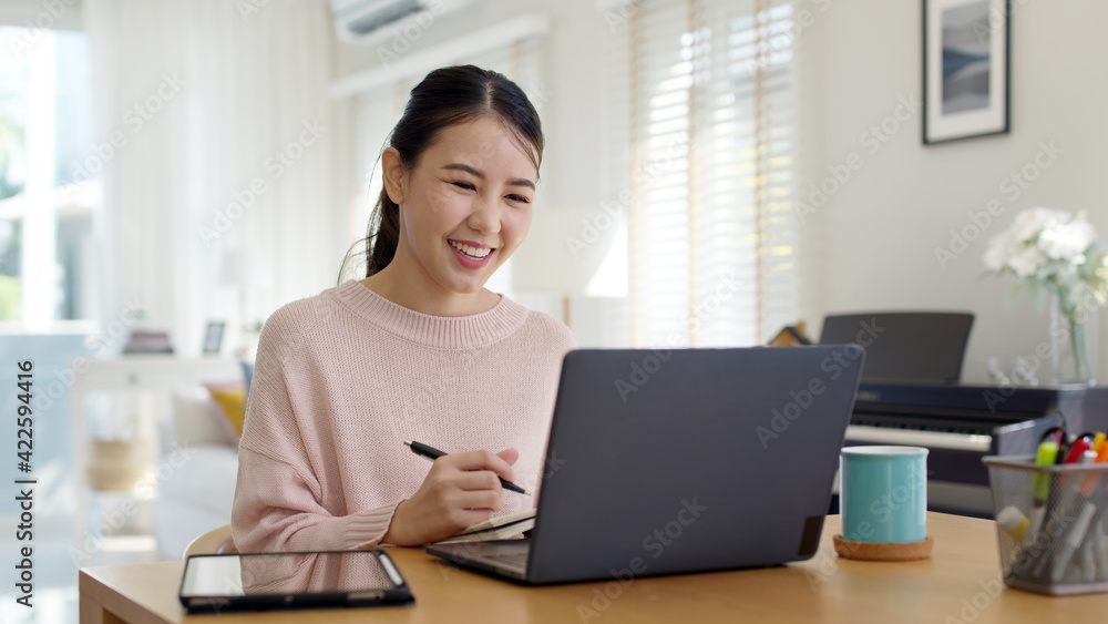 Young attractive business asian woman talking about sale report in video call conference on notebook computer online meeting in working from home, Working remotely and Social isolation concept. Young attractive business asian woman talking about sale report in video call conference on notebook computer online meeting in working from home, Working remotely and Social isolation concept.