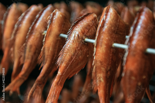 Smoking sea bass fish in sm...