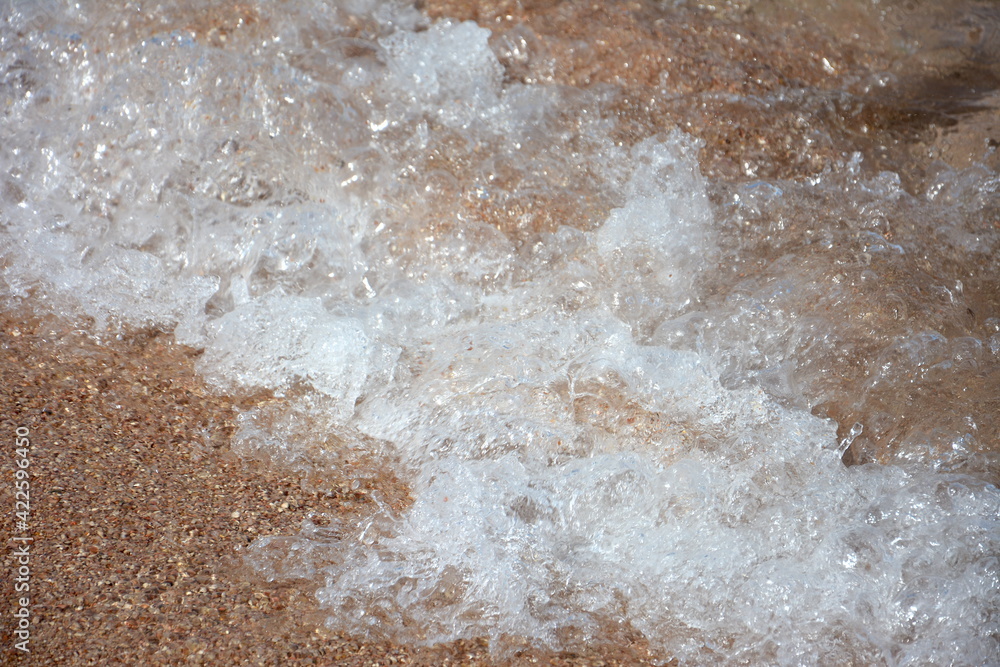 a small wave crashing the shore a small wave crashing the shore
