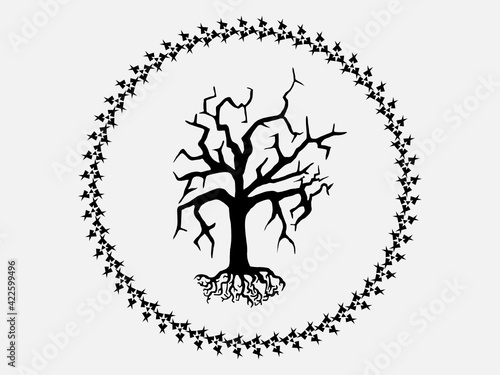 A withered tree with roots in a round frame.