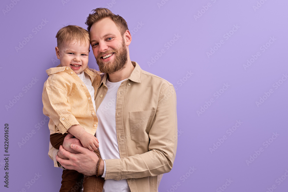 excited father and little son posing at camera smiling excited father and little son posing at camera smiling