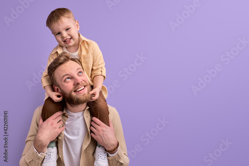 happy father and little son posing at camera smiling