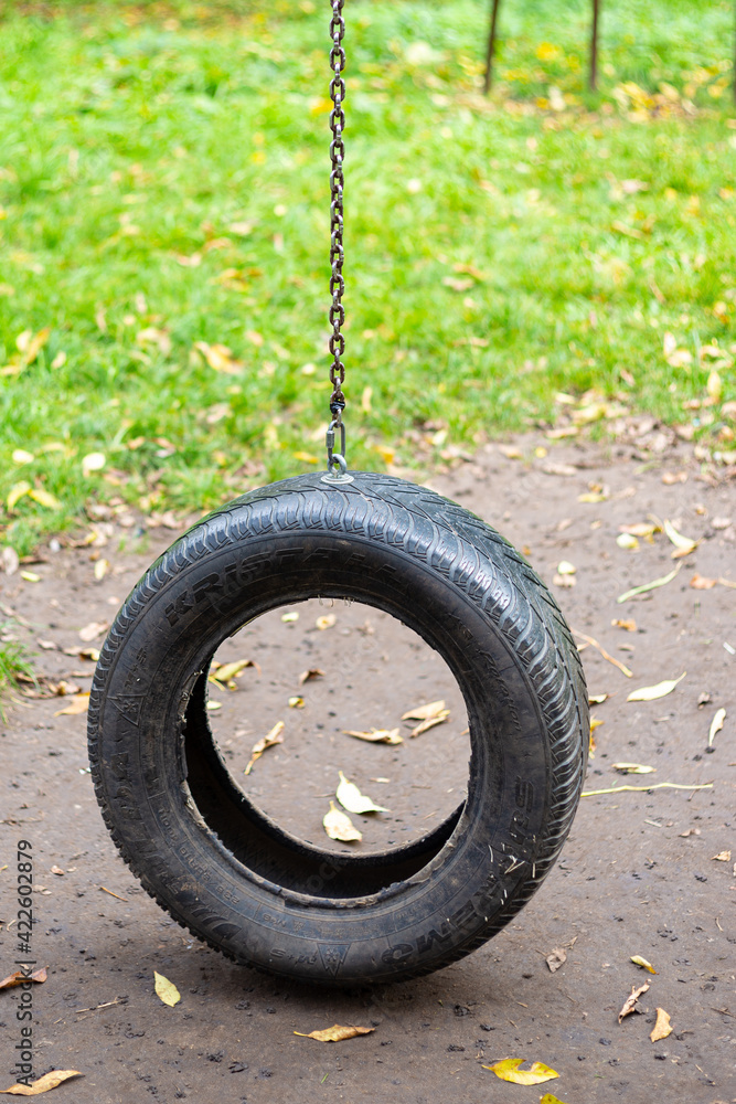 children's swing in the park, a swing from the tire children's swing in the park, a swing from the tire