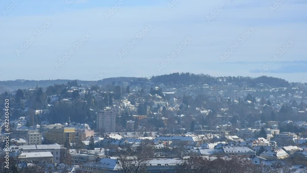 Cityscape of Graz with Church of the Sacred Heart of Jesus and historic buildings rooftops with snow, in Graz, Styria region, Austria, in winter Cityscape of Graz with Church of the Sacred Heart of Jesus and historic buildings rooftops with snow, in Graz, Styria region, Austria, in winter