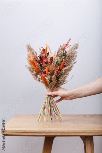 Bright trendy composition of dried flowers, home decor, a long-lasting gift of flowers and herbs