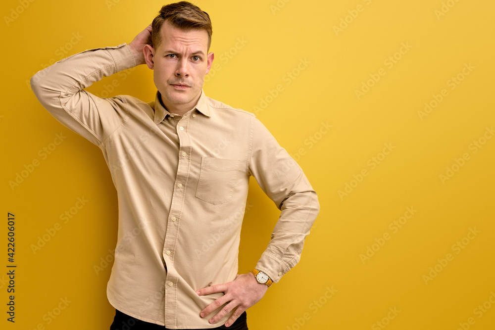 let s me think. man doubts his decision, isolated over yellow background let s me think. man doubts his decision, isolated over yellow background