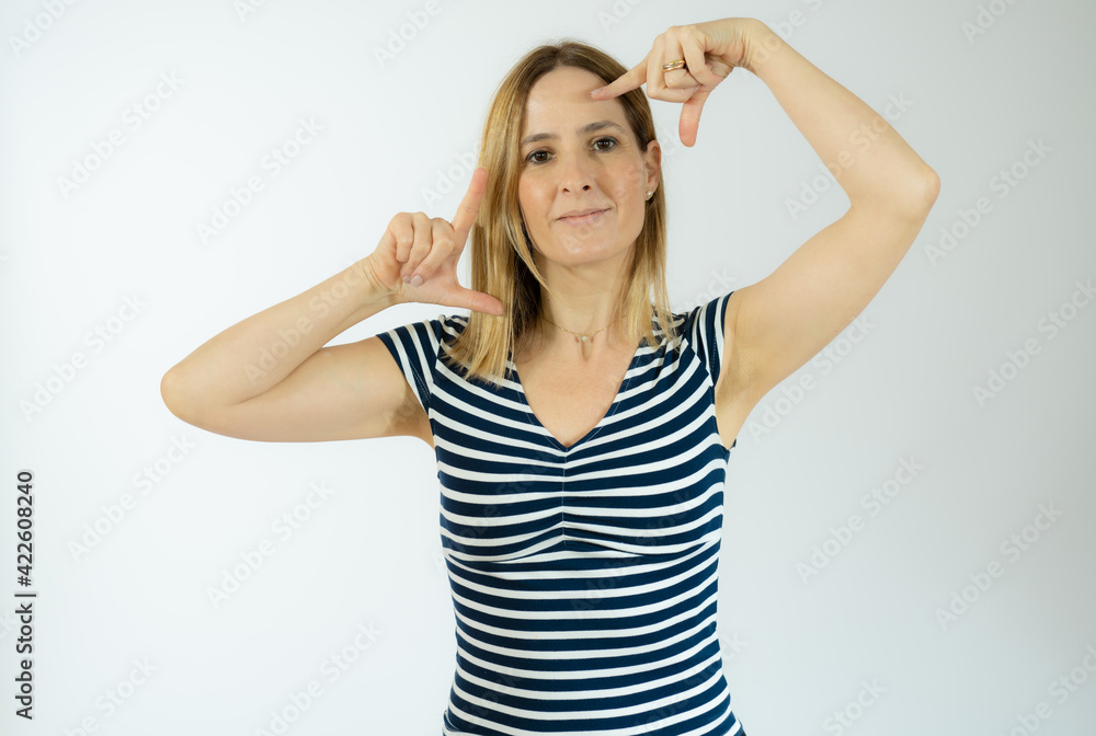 Happy woman making frame with fingers isolated on a white background