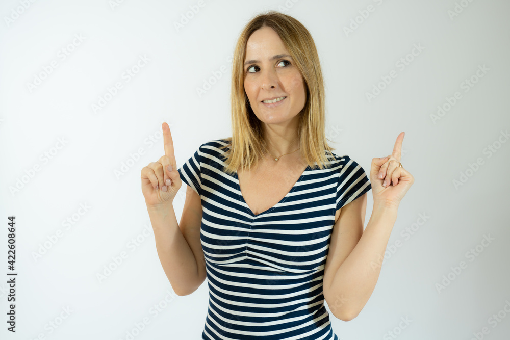 Portrait of beautiful young woman pointing up over white background. Portrait of beautiful young woman pointing up over white background.