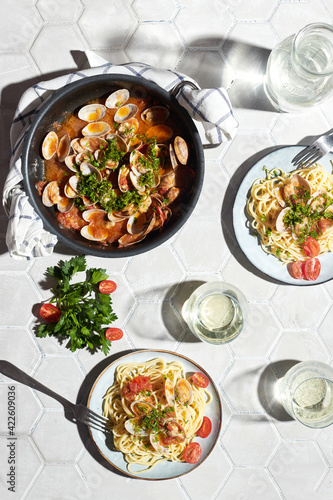 Mediterranean cuisine: pasta with seafood, with vongole. Italian lunch. Lifestal mood. Light background, top view photo