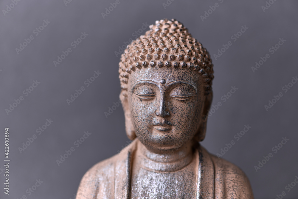 Meditating Buddha Statue on paper background.