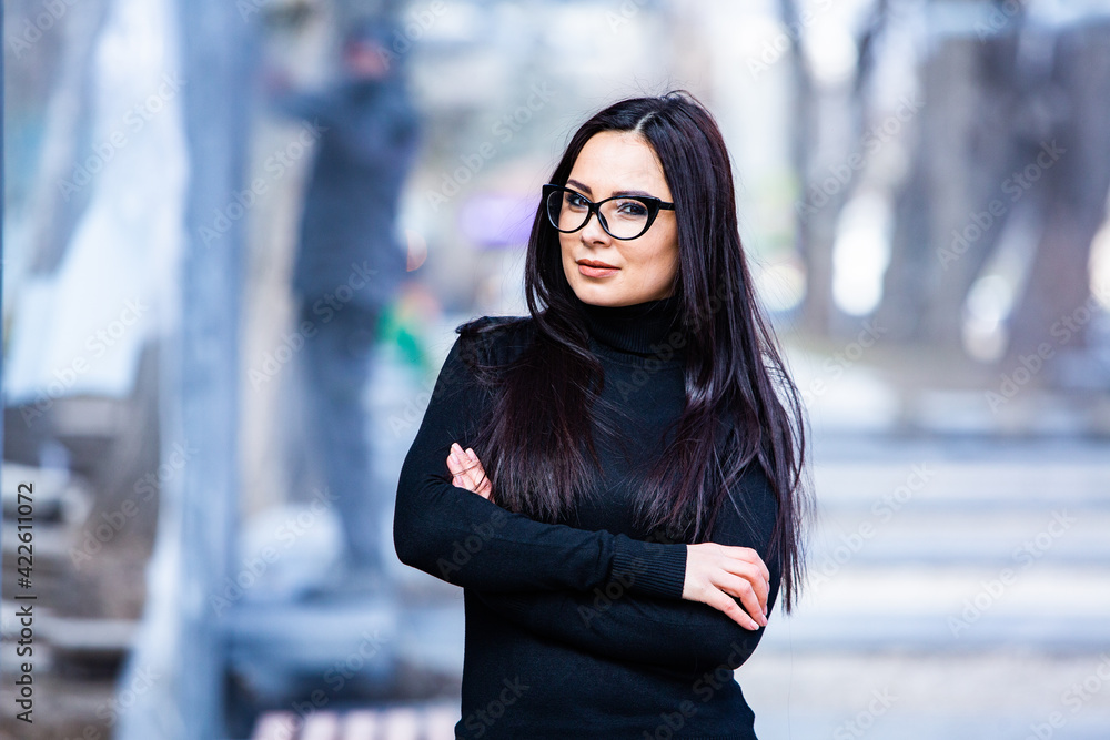 Beautiful russian girl dressed in black leather clothes and eyeglasses. Rock style european woman in urban background. Beautiful russian girl dressed in black leather clothes and eyeglasses. Rock style european woman in urban background.