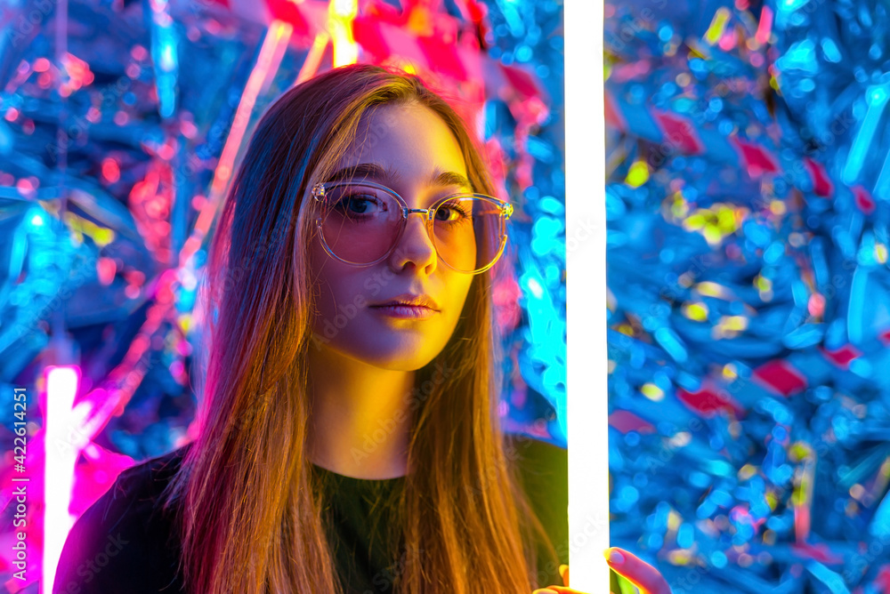 beautiful young girl wearing sunglasses in neon light. portrait of a ...