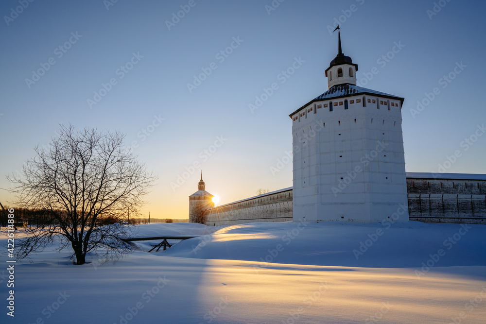 View of the Vologda Tower of the Kirillo-Belozersky Monastery on a sunny frosty morning against the background of the rising sun, Kirillov, Vologda region, Russia
