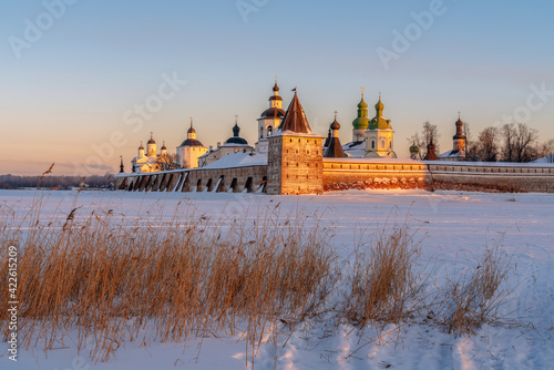 View of the Kirillo-Belozersky Monastery from the Siversky Lake in the rays of the setting sun on a frosty winter evening, Kirillov, Vologda region, Russia photo