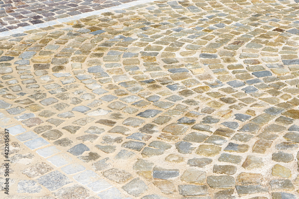 Pavement of granite in the old town in France. Texture for your design. Rock or stone street in curves. Pavement of granite in the old town in France. Texture for your design. Rock or stone street in curves.