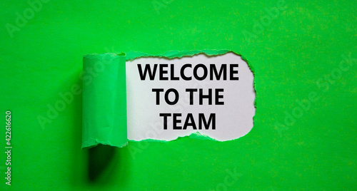 Welcome to the team symbol. Words 'Welcome to the team' appearing behind torn green paper. Beautiful green background. Business, welcome to the team concept, copy space.