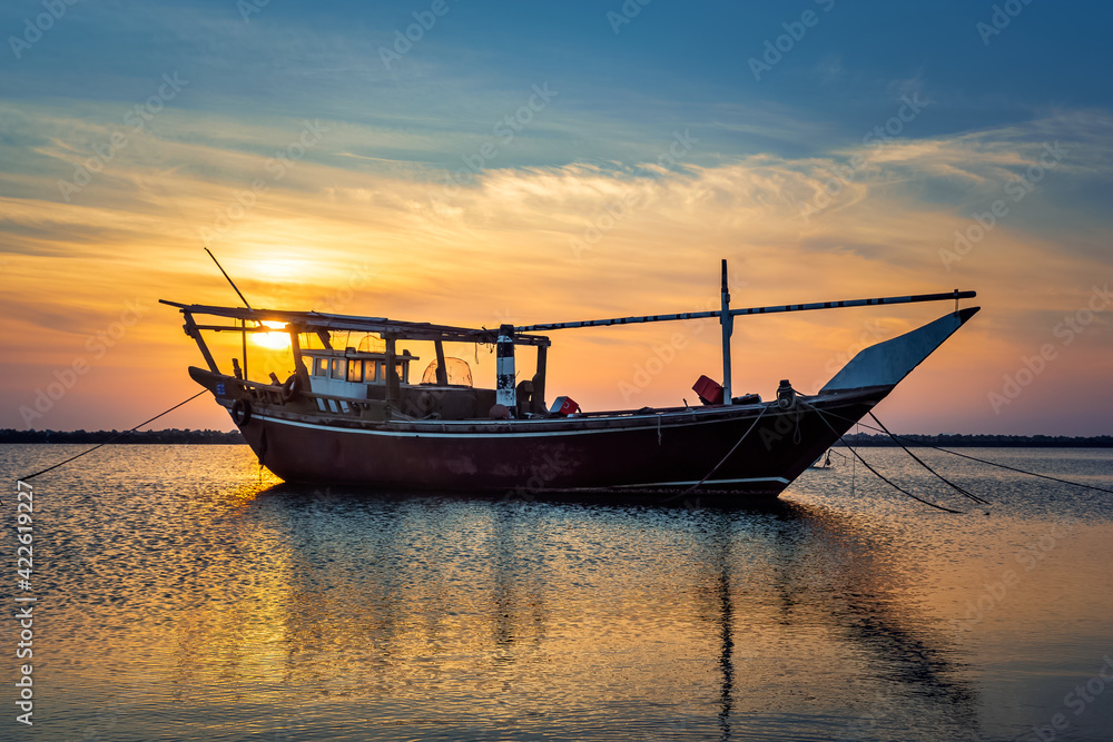 Single boat on Dammam sea side with sunrise background view. Dammam, Saudi Arabia.